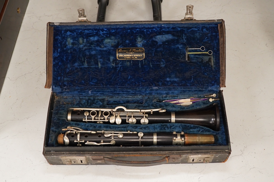 An early 20th century wooden Boosey and Hawkes clarinet in a fitted leather case